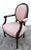 Antique Bergere Chair has a French Style. The Frame is Wood. Solid & Sturdy. Peach Colored Patterned Fabric. Minor Stains....
