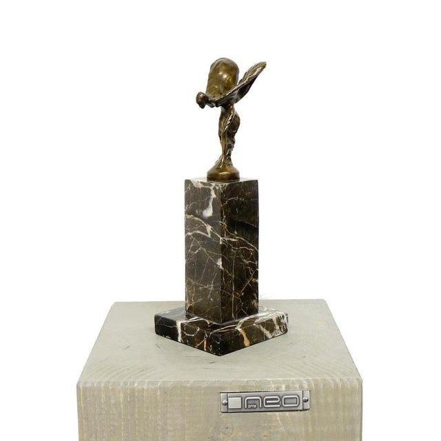Art Deco style bronze Spirit of Ecstasy sculpture mounted on a marble base. This modern decorative statue represents the...
