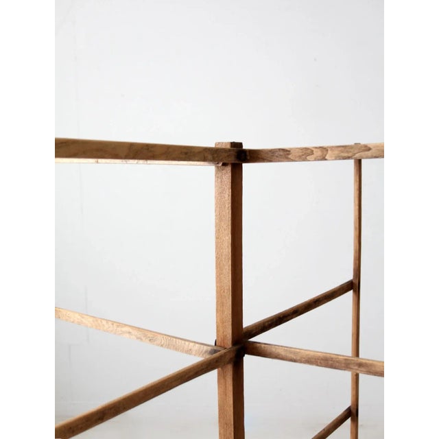 This 19th century antique wood drying rack features a center footed stand with four fold-out arms with slat wood bar...