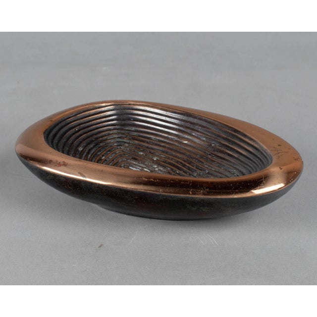 A vintage mid century modern bowl or ashtray by Ben Seibel for Jenfred-Ware. Heavy cast composite alloy plated in copper...