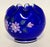 A striking example of Fenton Art Glass craftsmanship, this deep cobalt blue vase features a ruffled, scalloped rim and a...