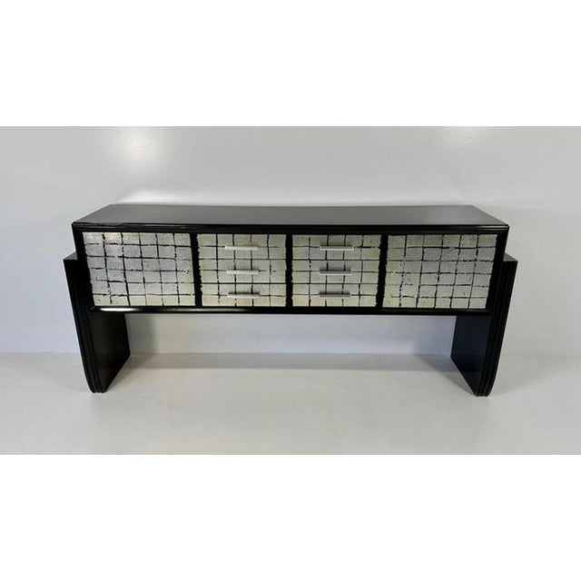 Elegant Italian sideboard produced in the 1950s, distinguished by the striking contrast between glossy black lacquer and...