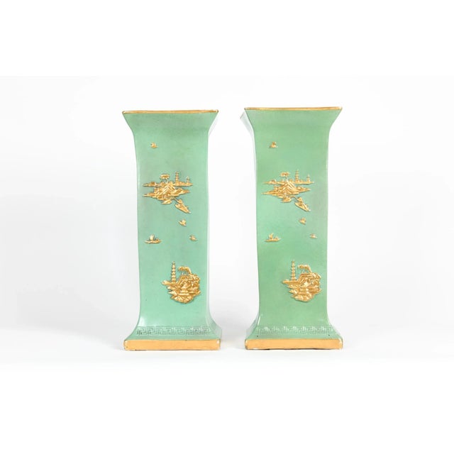 English pair glazed and parcel gilt design details porcelain decorative vases/pieces with asiatic details. Each piece is...