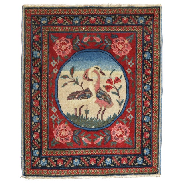 An authentic 20th century Persian pictorial rug with 2 loving swans.