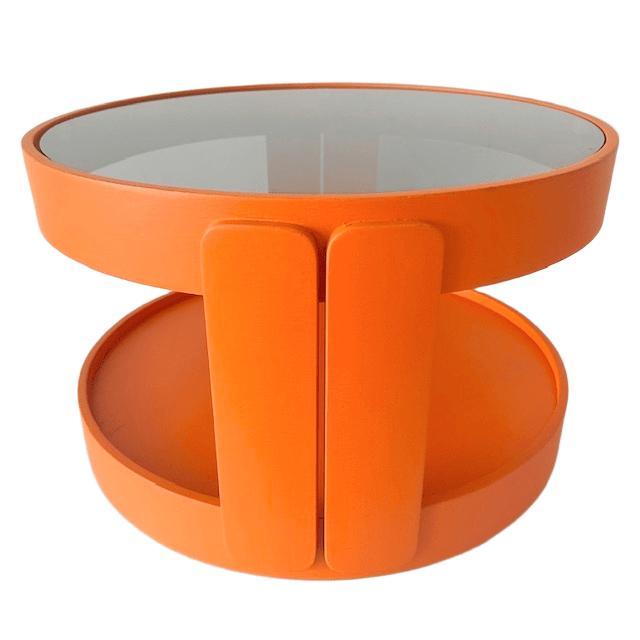 Cool vintage mid-century Space Age orange mobile side table on wheels from the 1960s. This table is made of wood and has a...