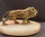 MCM gilt metal lion on an oval marble base. There is a hole on the right hand side which probably once held a one holder...