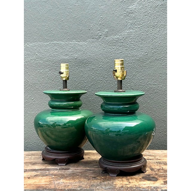This stunning pair of vintage table lamps features a vibrant emerald green glaze with a deep, lustrous finish that...