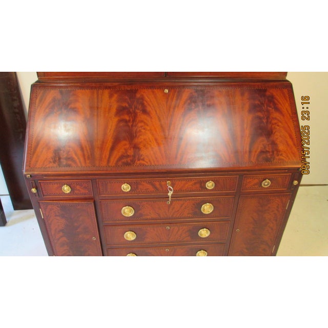 This is an incredible tall 2 piece solid mahogany secretary made by Irving and Casson. The upper case has unusual arched...