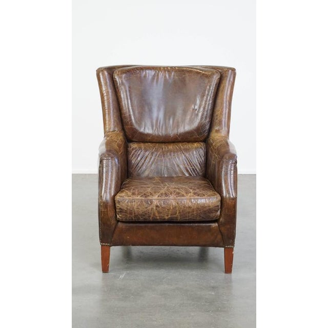 This stately and comfortable grained cowhide armchair with a timeless design and a beautiful color scheme. This timeless...
