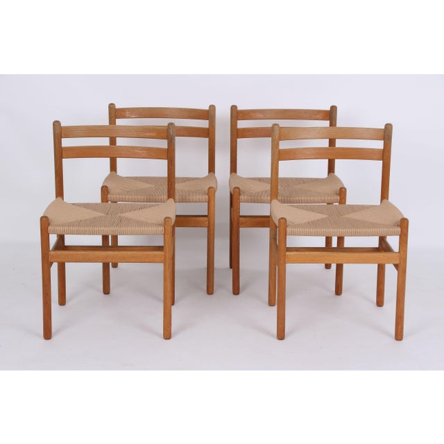 Four beautiful and sturdy dining chairs designed by Kurt Østervig. The chairs are made of light oak with a subtle patina...