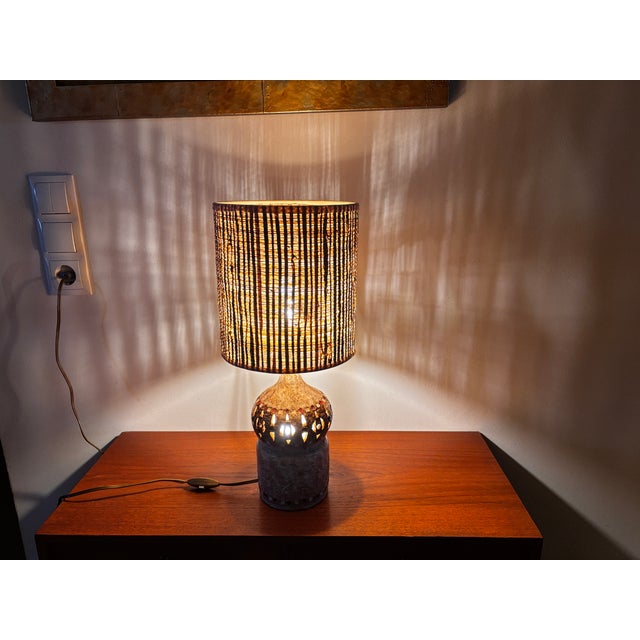 A bulb-shaped, openwork glazed ceramic lamp, finely decorated with colored cabochons. The lampshade has been remade to the...