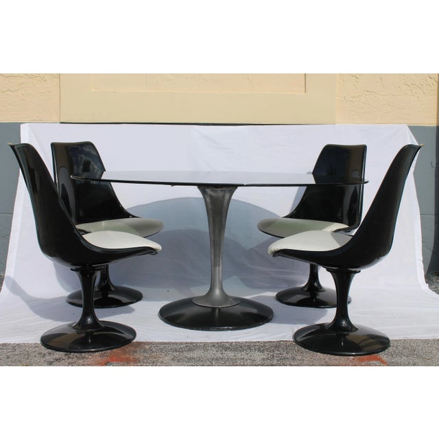 A spectacular 1960's Knoll style 5 piece dining set, including 4 refinished, black gloss, Tulip form, scoop back, heavy...