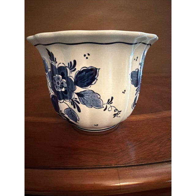 The Royal Goedewaagen "Blue Delft" Handwork Vase is a vintage piece of pottery from 1950, featuring a round shape and...