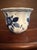 The Royal Goedewaagen "Blue Delft" Handwork Vase is a vintage piece of pottery from 1950, featuring a round shape and...