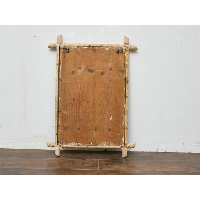A Midcentury bleached bamboo mirror with clean lines and a laid-back presence. The frame’s natural bamboo has been...