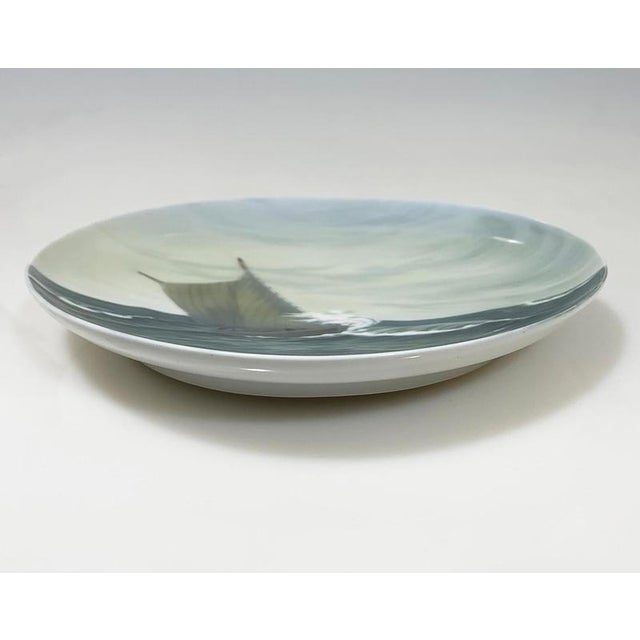 Seascape porcelain wall plate by Bing & Grøndahl, Denmark 1902-1914 A seascape scene with wooden sailboat on rough waves...