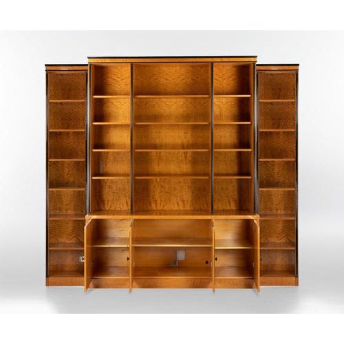 Vintage bookcase realized in Art Déco style by an italian manufacture in 1970s. Flamed maple veneer, ebonized wood...