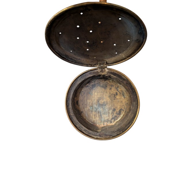 Brass bed warmer featuring an etched bird motif on the hinged pan lid, which has small air holes and measures 12 inches in...