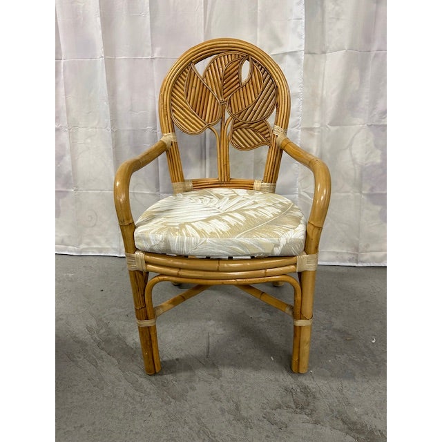 Vintage pencil reed rattan bamboo tropical leaf armchair to float in your space. This chair was handmade and imported from...
