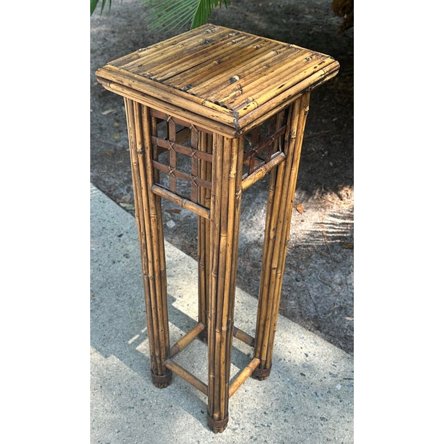Cute vintage rattan plant stand perfect to use in a corner with a fern or topiary. Sturdy. Measures 29” tall, 10” square.