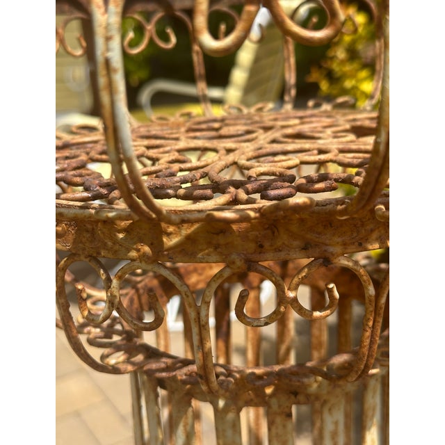 Decorative metalwork French plant stand like this one served a dual purpose: to elevate plants for better display and to...
