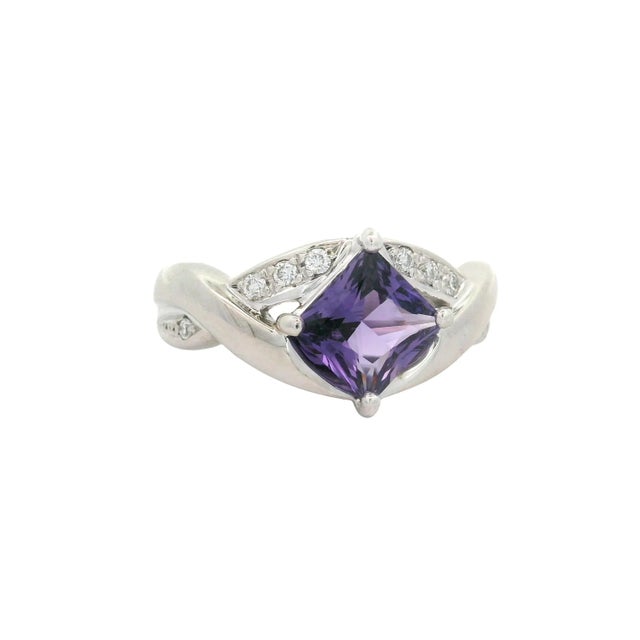 A contemporary fashion ring featuring a striking 1.51 carat square purple sapphire. The vibrant hue of the sapphire is...