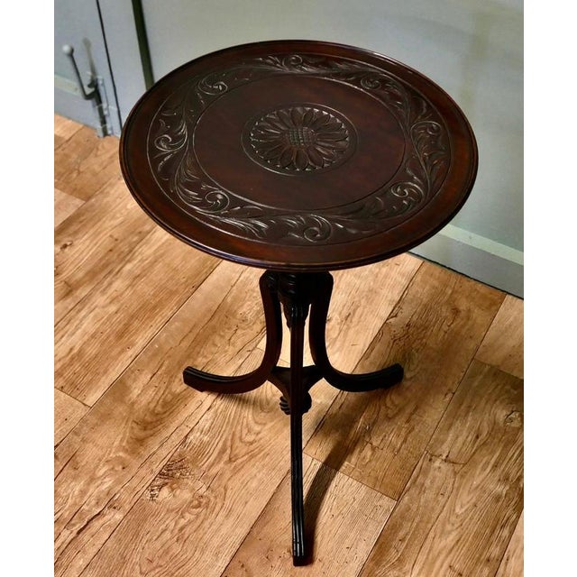 This lovely table stands on a very unusual three footed leg it has an exquisitely turned and split centre column with the...