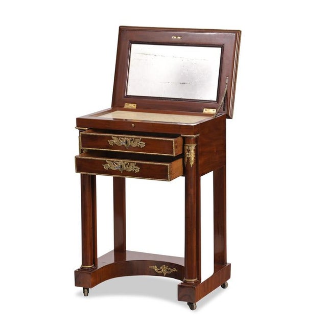 Console table / dressing table, France, circa 1800, mahogany, original brass hardware, two solid columns, standing on...