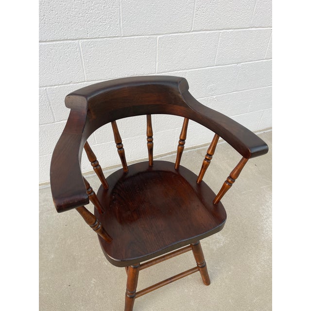 Enjoy this vintage Windsor inspired pub style captain’s chair! This chair features a solid wood construction with a curved...