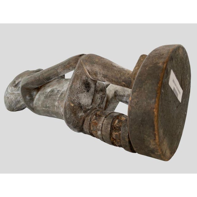 This item is an Old Dogon Carved Wood Fertility figure depicting a seated women looking out forward from the center of her...