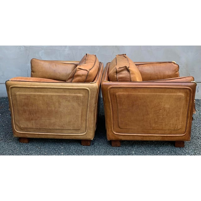 Exceptional pair of French 1970s saddle leather armchairs in the style of high-end European makers such as Roche Bobois.....