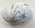 This charming artist signed Limoges box has been made in the form of an egg and sports a hand painted gold ear of rye...