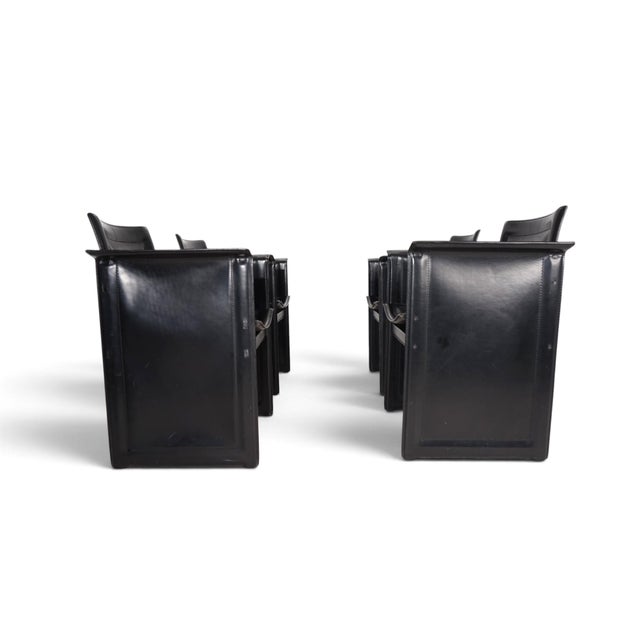 This set of 4 Solaria armchairs by Tito Agnoli for Arrben thrives on the consistent use of a single material: robust black...