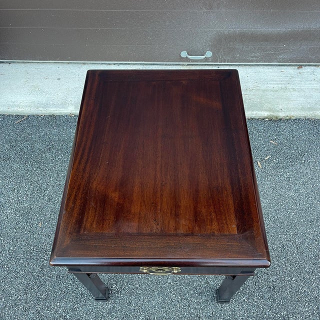 A late 20th century Henredon Fine Furniture Traditional Chippendale mahogany side or end table having a two tone banded...