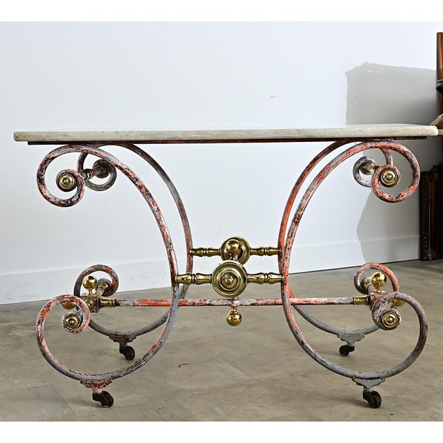 A dramatic French marble and ironwork table from the 18th century, which was used to display current offerings in a...
