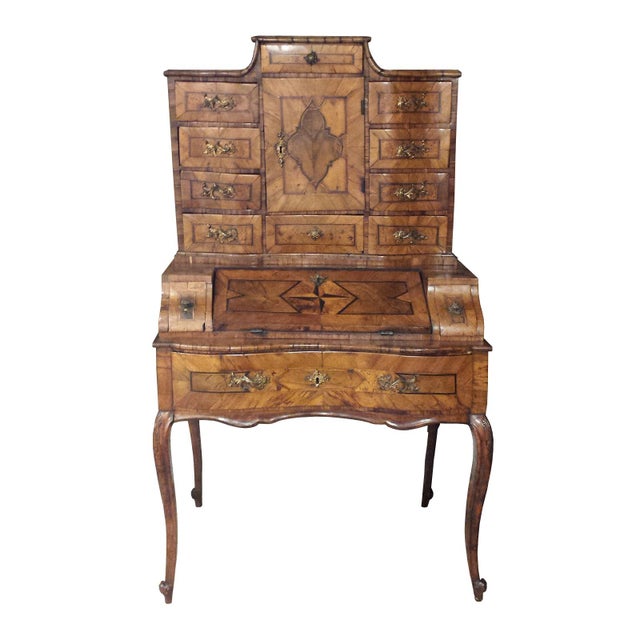 A fine South German Baroque desk. The upper case with a central blind cupboard flanked with small drawers. All of the...