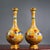 This is a striking and vibrant pair of matching cloisonné enamel vases. Featuring an elegant, elongated bottle form with a...