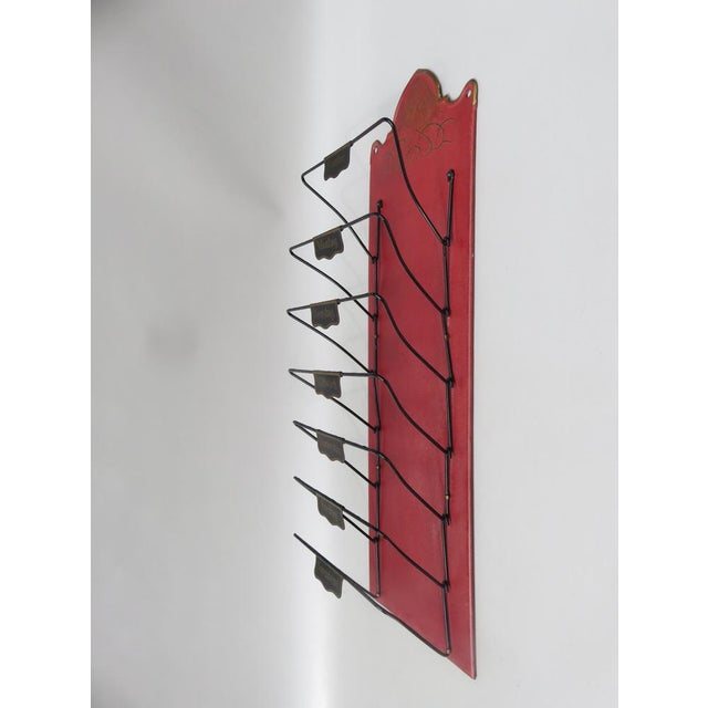 A wall newspaper stand from a cafe or restaurant from the Art Nouveau period with subjects for the individual days of the...