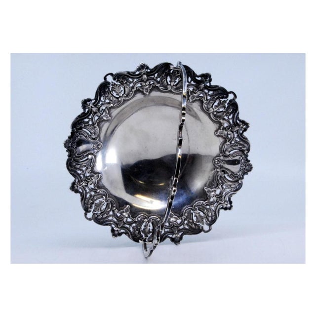 Silver Basket for with Tilting Handle, Shells and Palms, in Very Good conditions. Designed 1890 to 1919 This piece has an...