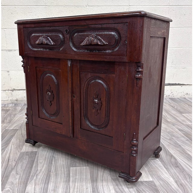 This is a beautiful antique Victorian Eastlake-style walnut cupboard, washstand, or nightstand dating to circa 1880–1890....