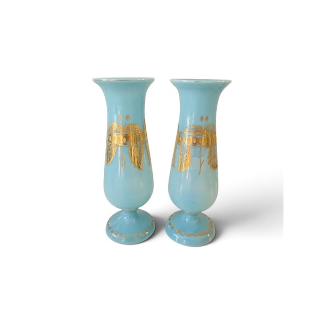 An exquisite pair of antique late 19th-century French blue opaline glass vases. Each vase features a classic trumpet or...