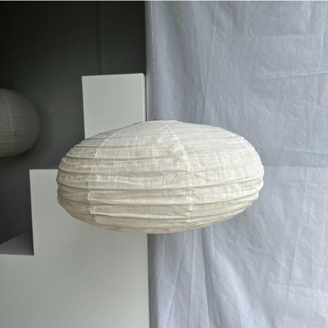 Large oval, flattened pendant light in Japanese-style rattan and natural linen. Beautifully handcrafted: natural rattan...