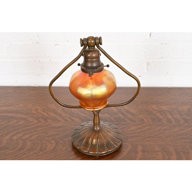 A gorgeous Arts & Crafts or Art Deco period bronze harp desk lamp or table lamp By Tiffany Studios (base signed to the...