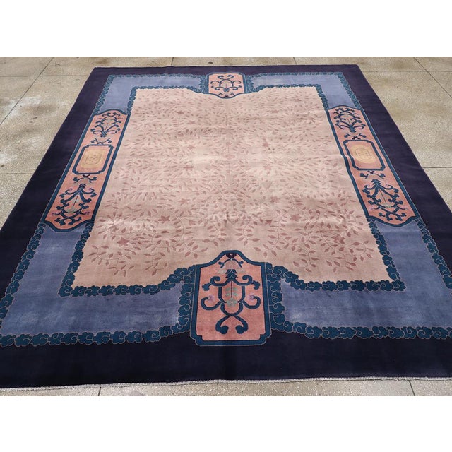 This mid-20th century Chinese Art Deco rug, measuring 10' 0" x 11' 8", showcases a refined and sophisticated design that...