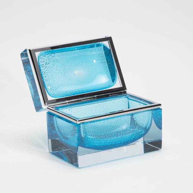 An exquisite showcase of contemporary Murano craftsmanship, this hand-blown giant box in aqua blue is a sculptural...