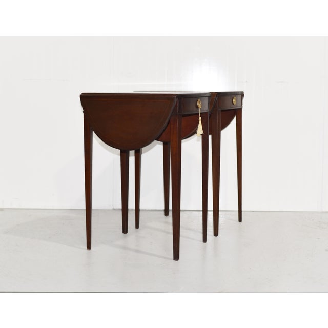 A classic, versatile pair with a clever twist. These mid century traditional side tables feature warm brown wood, tapered...