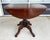 This antique mahogany drop-leaf table features a space-saving round top that opens to provide additional surface area when...