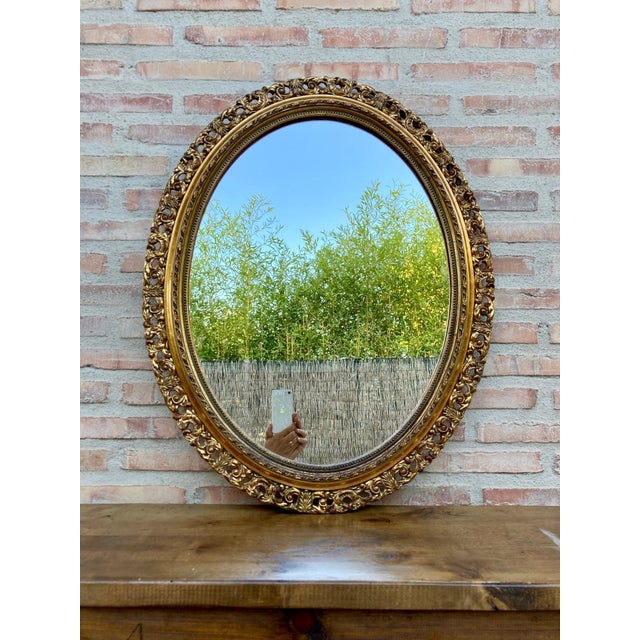 A magnificent oval shaped gold mirror, which has a mirror in perfect condition for use. Its beautifully carved gilt wood...