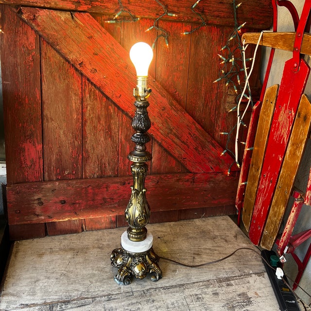 A charming vintage table lamp featuring intricate brass detailing and a sturdy marble base. Adds timeless character and...