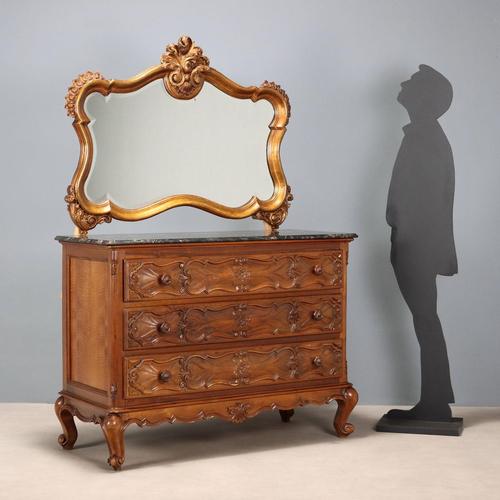Baroque-style walnut chest of drawers. Three drawers front carved with scrolls and curls, curved feet culminating in...